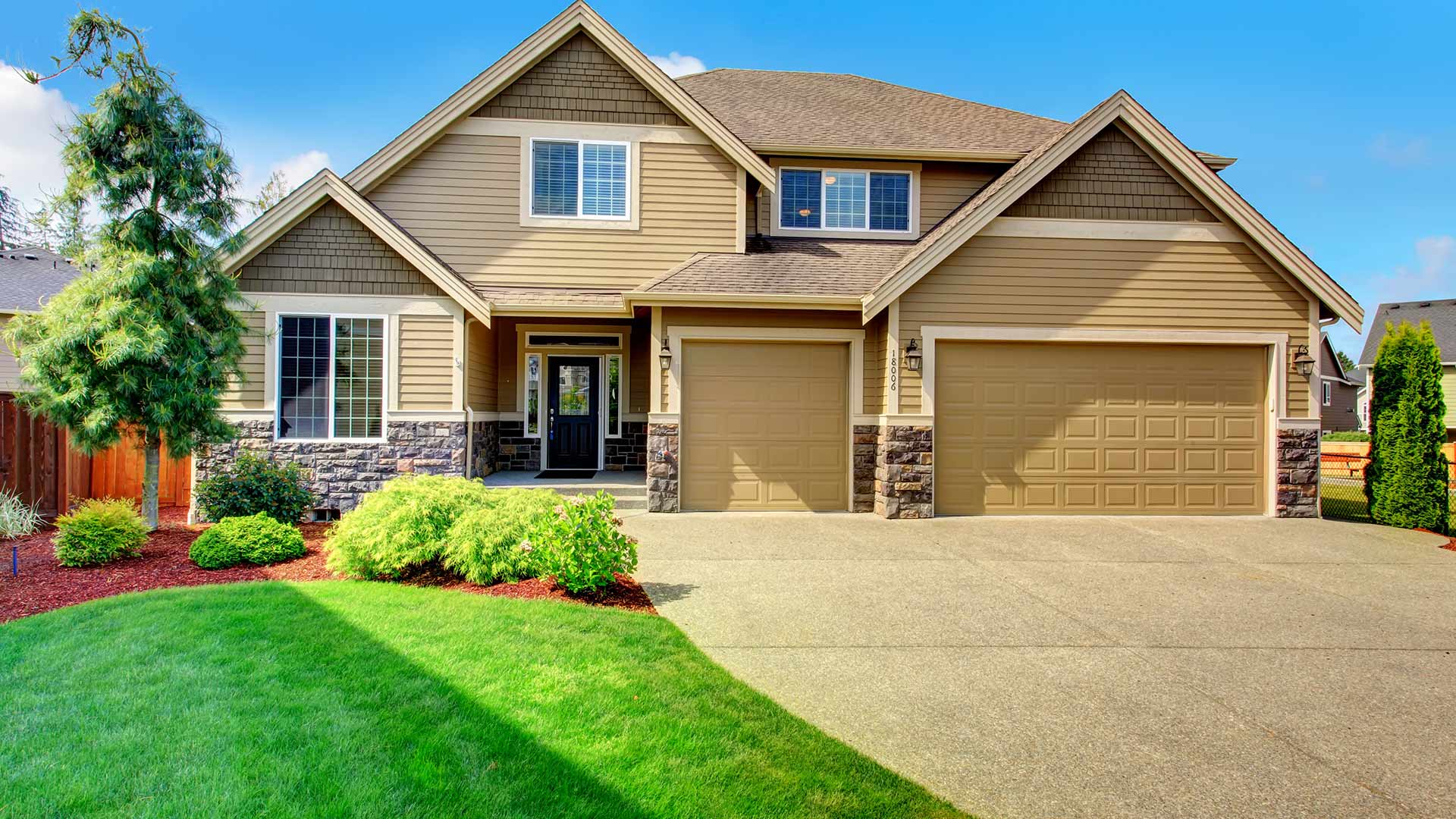 Beautifully maintained lawn and landscape beds on a property in Eagle Lake, MN.