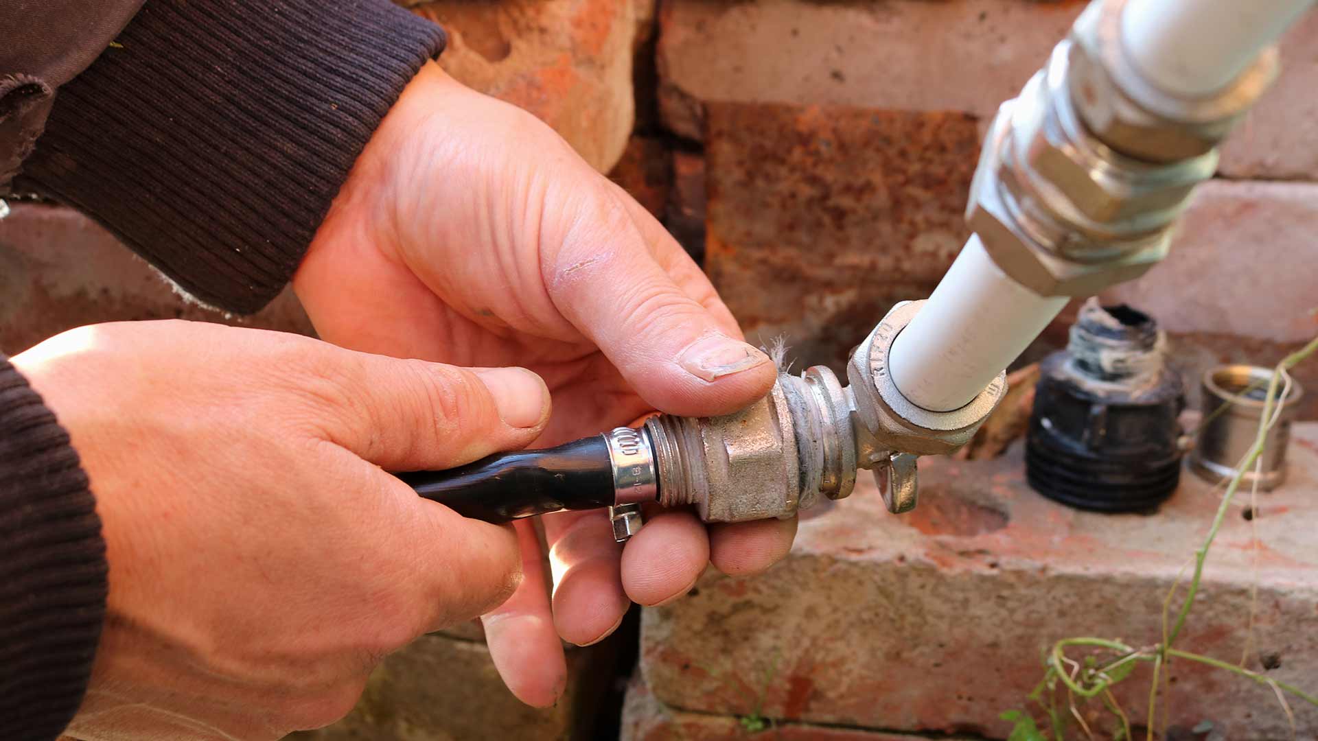 Irrigation expert repairing a water line at a home in Mankato, MN.