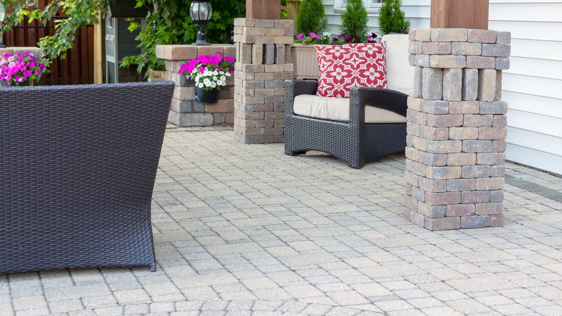 A paver patio with pergola and furniture in our client's backyard in Nicollet, MN.