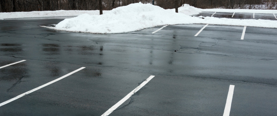 Cleared parking lot with mounds of snow paved away in St. Peter, MN.