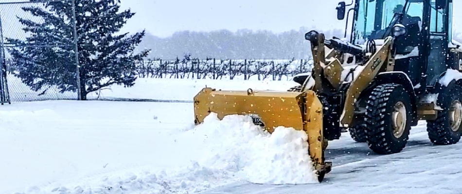 Commercial plow clearing road of snow in North Mankato, MN.