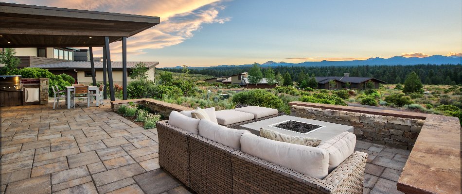 An outdoor living space complete with fire pit and kitchen behind our client's home in Elysian, MN.