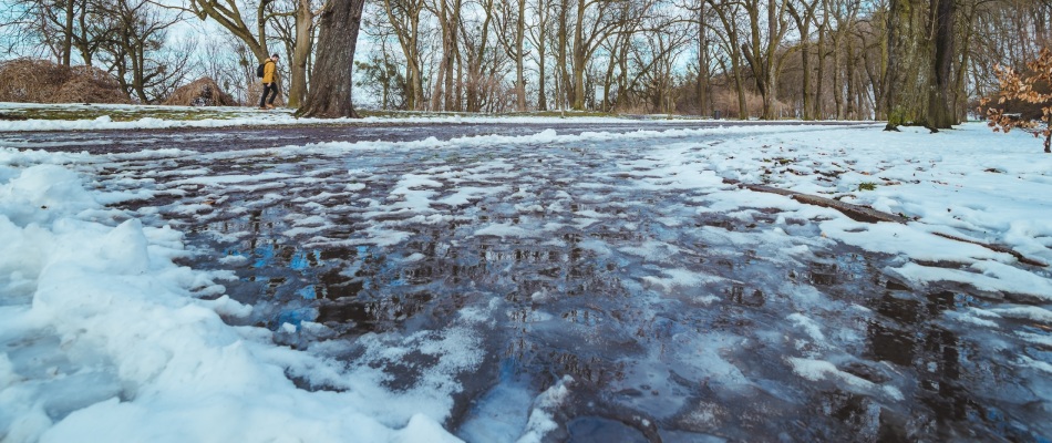 Deicing solution applied to sidewalk in Mankato, MN.