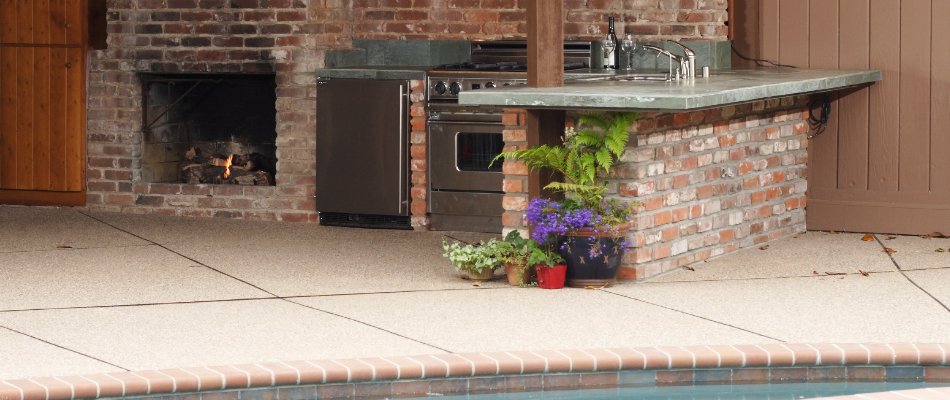 Rustic outdoor kitchen with brick walls installed by our team for a client in Elysian, MN.