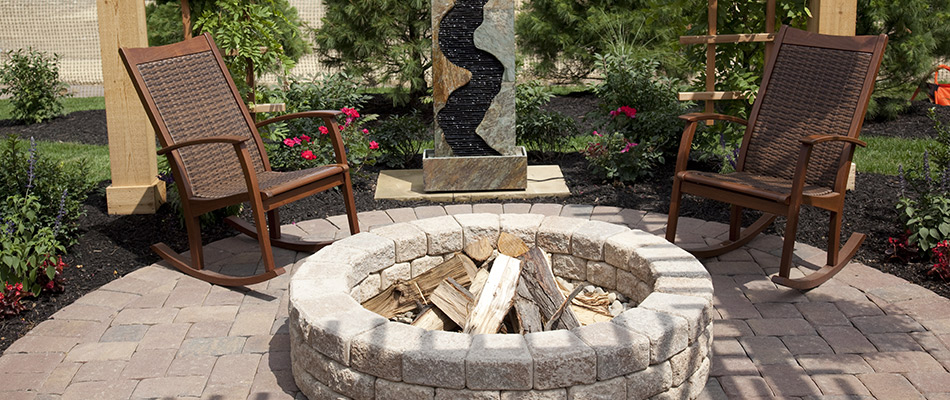 Paver fire pit installed over patio in St Peter, MN.