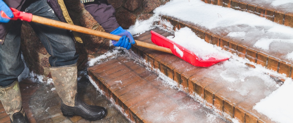 Professional clearing outdoor steps free of slush and snow in North Mankato, MN.
