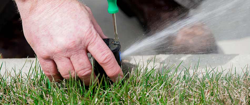 Repairing an irrigation system sprinkler head at a home in Eagle Lake, MN.