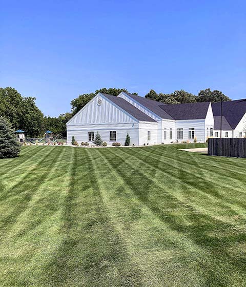 Large yard with healthy grass near a home in Mankato, MN.